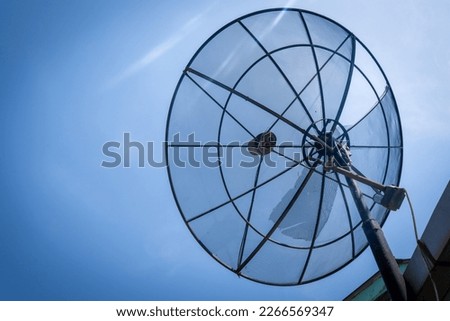 Big C-Band Satellite dish on roof of a house. Option to get free cable TV signal.