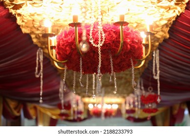 A big chandelier hangs on top of the wedding decoration - Shutterstock ID 2188233793