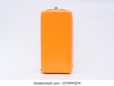 Big Cheese Head In Yellow Vacuum Package. Cheese Block Isolated On White Background With Clipping Path Included.