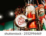 Big Christmas nutcracker with drum at traditional Christmas  market. Decorative nutcracker figurine wishing merry Christmas