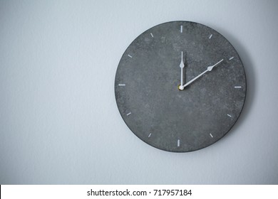 Big Clock Hanging On Grey Wall