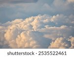 Big clouds in the sky gather together to form rain clouds.