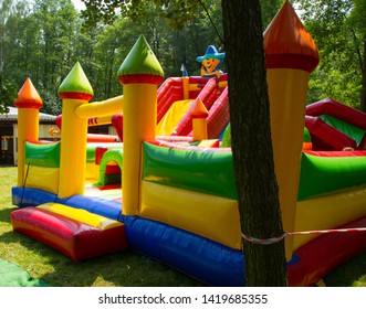 Big, colorful inflatable castle labyrinth  into the trees - Shutterstock ID 1419685355