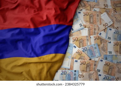 big colorful waving national flag of armenia on a euro money background. finance concept