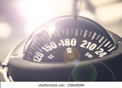 A big compass on a boat showing direction