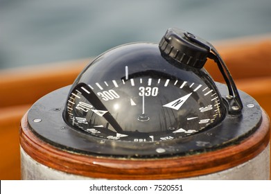 A Big Compass On A Boat Showing Direction