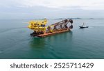 Big Construction on ship. Tender Drilling Oil Rig on Barge Ship transportation Rid to Oil Rig in The Middle of The Ocean. Five Tug boat pulling Construction