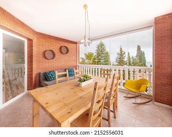 Big covered terrace of a summer holiday property with wood table,sofas and sea view. - Shutterstock ID 2152556031