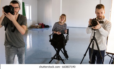 Big Creative Team Working In Studio. Photographer And Videographer Working While Art Director Observing. Production Of Commercials Backstage