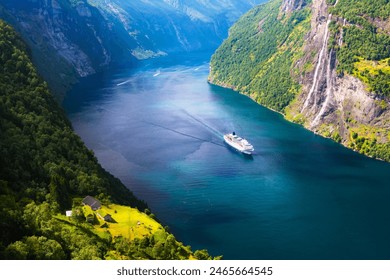 A big cruise liner in clear azure water of Sunnylvsfjorden fjord near Geiranger village in western Norway. Famous Seven Sisters waterfalls on background - Powered by Shutterstock