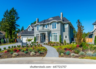 Big custom made luxury house with nicely landscaped front yard  in the suburbs of Vancouver, Canada.