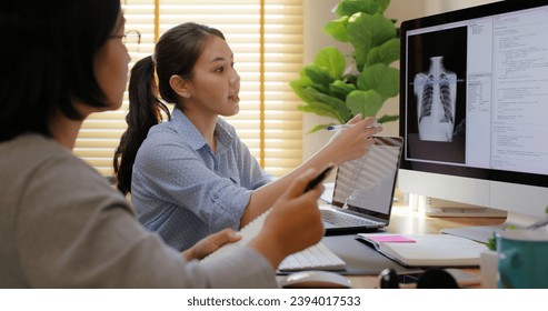 Big data AI coding screen for asian future health care smart tech IT solution. Asia team woman people code analyst job work on science project Lung X-ray scanner medtech tools meeting talk at office.