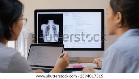 Big data AI coding screen for asian future health care smart tech IT solution. Asia team woman people code analyst job work on science project Lung X-ray scanner medtech tools meeting talk at office.