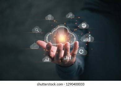 Big data analytics and business intelligence concept with chart and graph icons on a digital screen interface and a businessman in background
