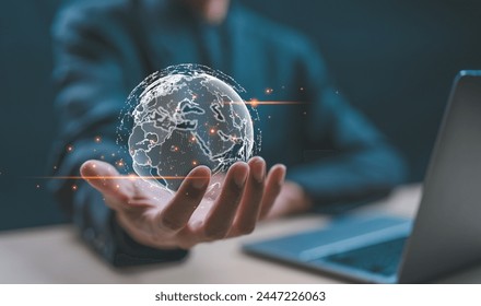 Big data analytics and business intelligence concept. Businessman holding Global network connection. World map point and line composition concept of global business.Digital link tech. - Powered by Shutterstock