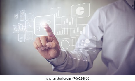 Big data analytics and business intelligence (BI) concept with chart and graph icons on a digital screen interface and a businessman in background