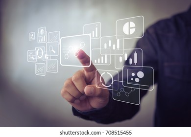 Big data analytics and business intelligence concept with chart and graph icons on a digital screen interface and a businessman in background