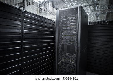 A Big Data Center Storage Ranges Cover And Cloud Services. Black Cabinets In A Large Room Servers.