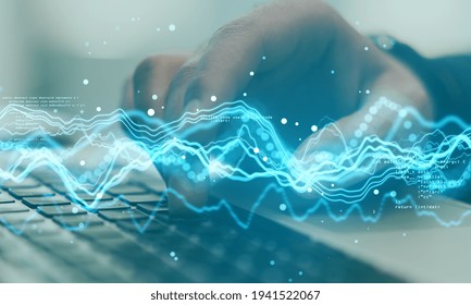 Big data concept with digital waves and abstract programming code on backdrop with man hand typing on laptop keyboard