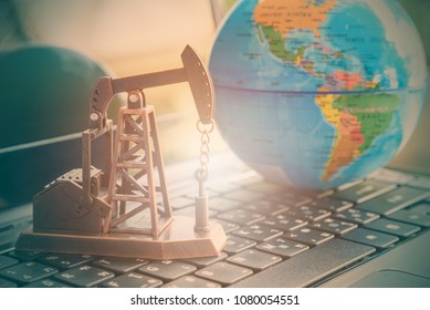 Big data and data mining concept : Oil or petroleum pump jack on a laptop, depicts the collective data or extraction technic that are performed on large sets / volume of data, uncovering information. - Shutterstock ID 1080054551