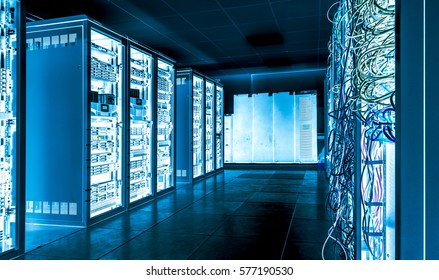 Big datacenter with connected servers and internet cable infrastucture. In blue bright tones
