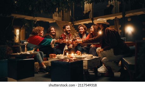 Big Dinner Garden Party Celebration with Friends on a Warm Summer Evening. Beautiful People Enjoy Life on a Terrace, Talk, Relax on Weekend, Have Fun, Drink Wine, Give Toasts and Eat Homemade Food. - Powered by Shutterstock