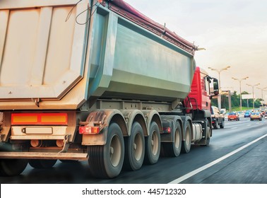 Big Dump Truck Goes In The Evening On Highway