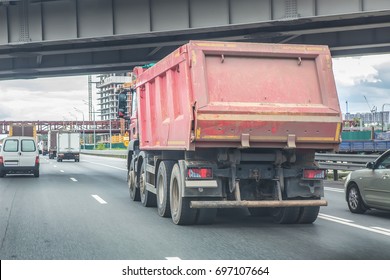 Big Dump Truck Goes In The Evening On Highway