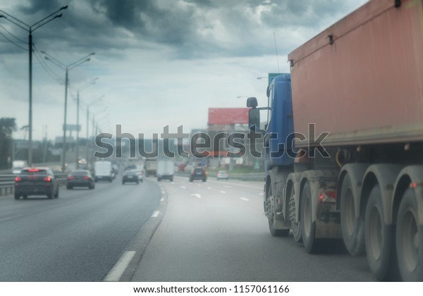 big dump truck\
goes in the evening on\
highway
