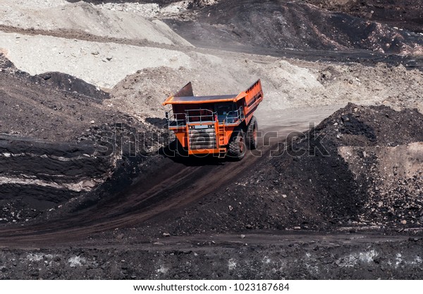 Big dump truck or Mining truck is mining machinery,\
or mining equipment to transport coal from open-pit or open-cast\
mine as the Coal Production. This picture show dump truck on\
open-pit coal mine.