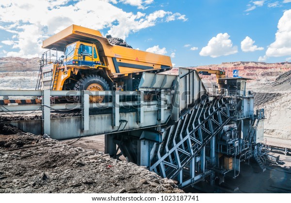 Big dump truck is mining machinery, or mining\
equipment to transport coal from open-pit or open-cast mine as the\
Coal Production. Loading of coal ore from dump truck to the crusher\
house.