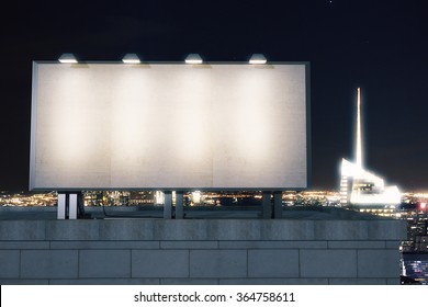 Big empty billboard on the background of the city at night, mock up