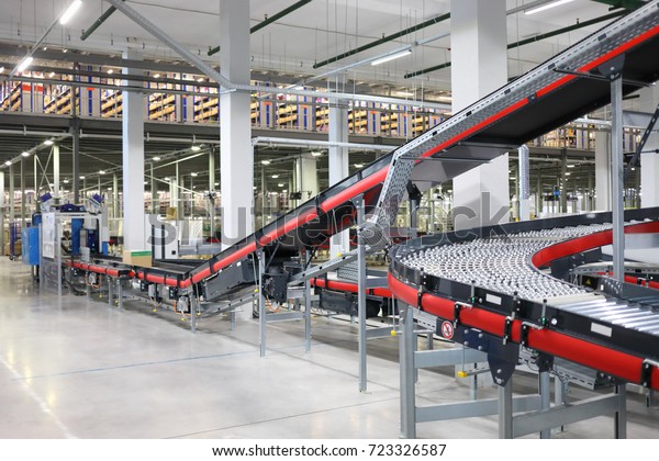 Big empty modern workshop with conveyors for\
sorting of goods