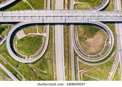 Big Empty Road Junction On Green Land Aerial View. Highway And Half Clover Leaf Junction With Traffic