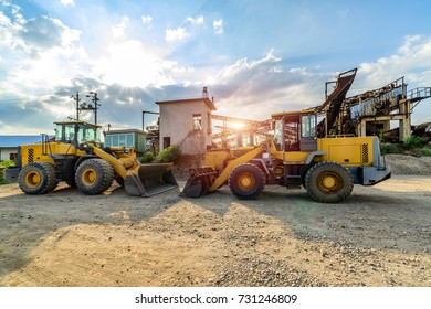 Big excavator on new construction site, in the background the blue sky and sun
 - Shutterstock ID 731246809