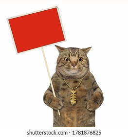 The Big Eyed Beige Cat With A Gold Fish Bone Pendant Is Holding A Red Blank Sign. White Background. Isolated.