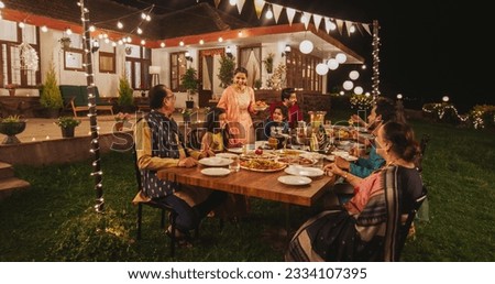 Big Family Celebrating Diwali: Indian Family in Traditional Clothes Gathered Together on a Dinner Table in a Backyard Garden Full of Lights. Moment of Happiness on a Hindu Holiday