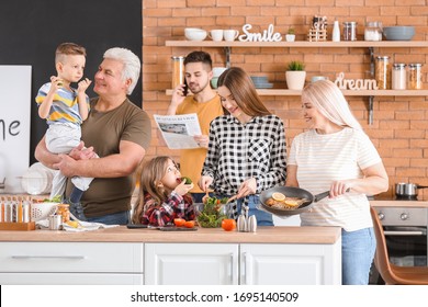 Big Family Cooking Together In Kitchen