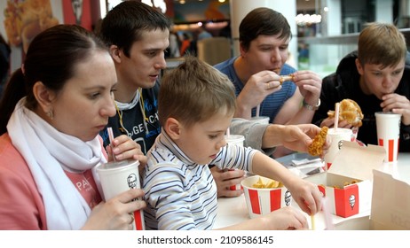 Big Family Eating Fried Chicken And French Fries Together At A Fast Food Restaurant. Novosibirsk, Russia, 2021