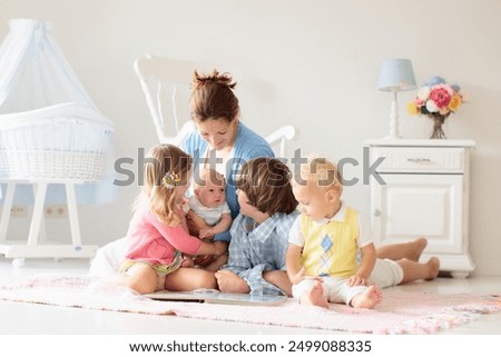 Similar – Children feeding doll with cookie sitting over the bed