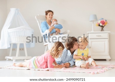 Similar – Children feeding doll with cookie sitting over the bed