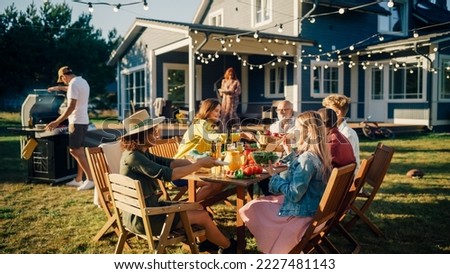 Big Family and Friends Celebrating Outside in a Backyard at Home. Diverse Group of Children, Adults and Old People Gathered at a Table, Kids Running and Having Fun.