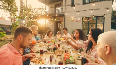 Big Family Garden Party Celebration, Gathered Together at the Table Relatives and Friends, Young and Elderly are Eating, Drinking, Passing Dishes, Joking and Having Fun. - Shutterstock ID 1294608067