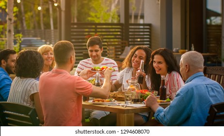 Big Family Garden Party Celebration, Gathered Together at the Table Relatives and Friends, Young and Elderly are Eating, Drinking, Passing Dishes, Joking and Having Fun.