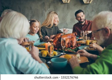 Big family happy celebrate thanksgiving day gather mature generation small little kids sit table eat evening feast dinner corns vegetables wine chicken harvest have feasting in house indoors