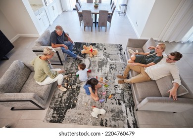 Big Family In Living Room Home With Parents, Baby Or Children Play On Carpet For Growth, Development And Wellness. Overhead Grandmother And Grandfather Talking To Kids For Language Learning In Lounge