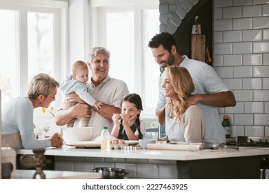 Big family, love and cooking in home kitchen, bonding or having fun. Support, care and grandparents, father and mother, baby and girl baking, learning and talking while enjoying quality time together - Powered by Shutterstock