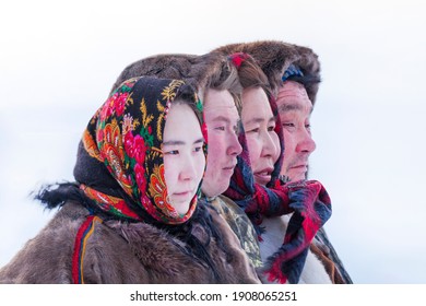 Big family in the national winter clothes of the northern inhabitants of the tundra, the Arctic circle, ethnic Nenets. Portrait of people in profile all together. - Shutterstock ID 1908065251