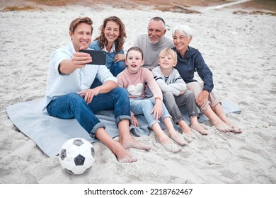 Big family, phone selfie and beach holiday, vacation or trip outdoors. Grandparents, parents and children with soccer ball on sandy seashore, bonding and taking photo for happy memory or social media - Powered by Shutterstock