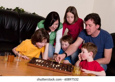 Big Family Is Playing A Boardgame In The Livingroom